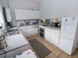 A kitchen with sink and appliances at Tawe Cottage in Swansea