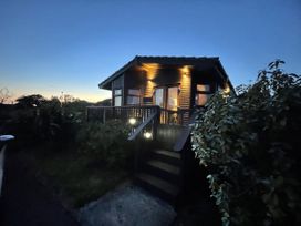 A house with a deck and steps at Lamorna in Sennen