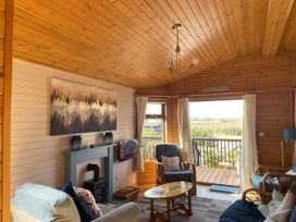 A living room with a table and chairs at Lamorna Sennen
