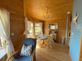 A dining room with a table and chairs at Lamorna Sennen