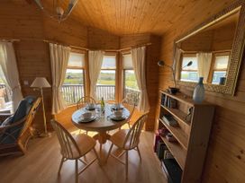 A dining room with a table set for a meal at Lamorna in Sennen