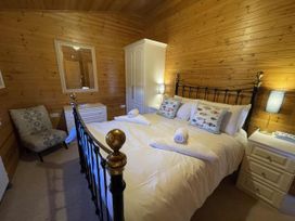 A bedroom with a bed and nightstand at Lamorna in Sennen