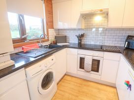 A kitchen with appliances and a sink at Lamorna Sennen