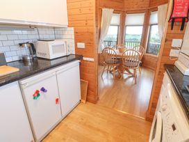 A kitchen with appliances and a dining area at Lamorna in Sennen