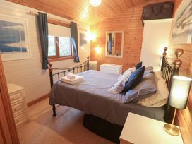 A bedroom with a bed and dresser at Lamorna in Sennen