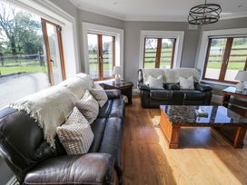 A living room with sofas and a coffee table at Woodlawn Retreat in Portanure near Lough Gowna