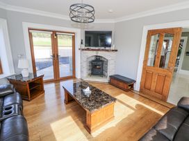 A living room with a fireplace and television at Woodlawn Retreat in Portanure near Lough Gowna