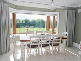 A dining room with a table and chairs at Woodlawn Retreat Portanure near Lough Gowna