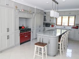 A kitchen with cabinets and an island at Woodlawn Retreat in Portanure near Lough Gowna