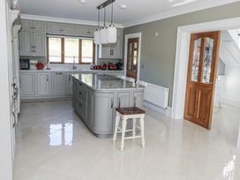 A kitchen with an island and bar stool at Woodlawn Retreat in Portanure near Lough Gowna