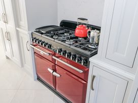 A stove with a kettle and cookware in a kitchen at Woodlawn Retreat in Portanure near Lough Gowna