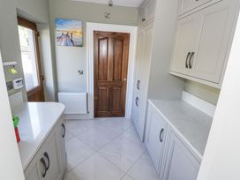 A utility room with cabinets and a door at Woodlawn Retreat in Portanure near Lough Gowna