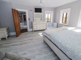 A bedroom with a bed and dresser at Woodlawn Retreat in Portanure near Lough Gowna