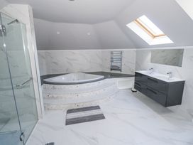 A bathroom with a bathtub and double sink at Woodlawn Retreat in Portanure near Lough Gowna