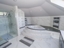A bathroom with a bathtub and shower at Woodlawn Retreat in Portanure near Lough Gowna