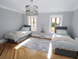 A bedroom with two beds and a lamp at Woodlawn Retreat in Portanure near Lough Gowna
