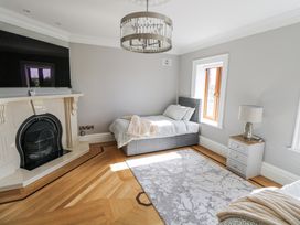 A bedroom with a bed and fireplace at Woodlawn Retreat in Portanure near Lough Gowna