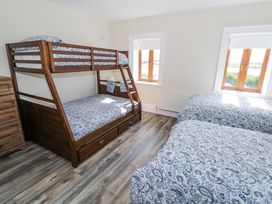 A bedroom with a bunk bed and a double bed at Woodlawn Retreat in Portanure near Lough Gowna