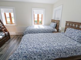 A bedroom with two beds and a bunk bed at Woodlawn Retreat in Portanure near Lough Gowna