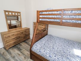 A bedroom with a bunk bed and a dresser at Woodlawn Retreat in Portanure near Lough Gowna