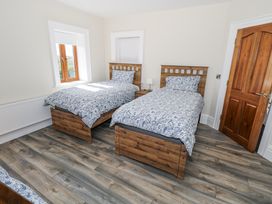 A bedroom with two beds and a window at Woodlawn Retreat in Portanure near Lough Gowna