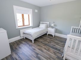 A bedroom with two beds and a window at Woodlawn Retreat in Portanure near Lough Gowna