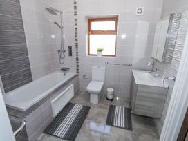 A bathroom with a bath tub and toilet at Woodlawn Retreat in Portanure near Lough Gowna
