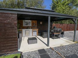 An outdoor patio with seating and a barbecue grill at Woodlawn Retreat Portanure near Lough Gowna