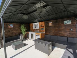 An outdoor patio with a sofa and bar area at Woodlawn Retreat in Portanure near Lough Gowna