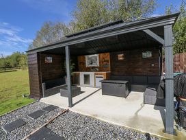 An outdoor seating area with furniture and a kitchenette at Woodlawn Retreat in Portanure near Lough Gowna