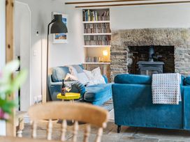 A living room with a sofa and a fireplace at Treovis Cottage in Callington