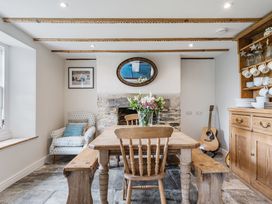 A dining room with a table and chairs at Treovis Cottage in Callington