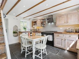 A kitchen with a table and chairs at Treovis Cottage in Callington