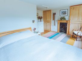 A bedroom with a bed and dresser at Treovis Cottage in Callington