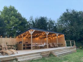 An outdoor structure with chairs and a hammock at Treovis Cottage in Callington