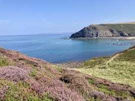 A coastal view with hills and ocean at Treovis Cottage in Callington