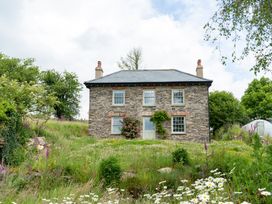 A house with flowers in front of it at Treovis Cottage Callington