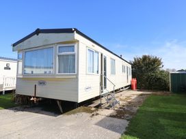 A mobile home with steps and gas bottles at Number 38 in Chichester