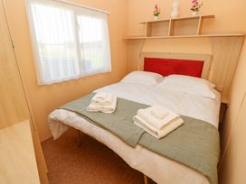 A bedroom with a bed and window at Number 38 in Chichester