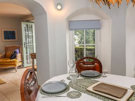 A dining room with a table set for a meal at Rookery Cottage in Lynton
