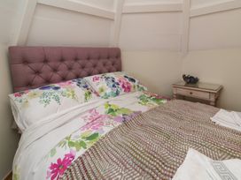 A bedroom with a bed and side table at Rookery Cottage in Lynton