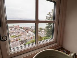 A window view overlooking rooftops and the sea at Rookery Cottage in Lynton