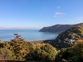 A coastal view with mountains and trees at Rookery Cottage in Lynton