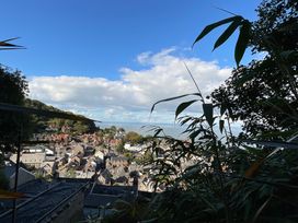 A view of buildings and the sea under a blue sky at Rookery Cottage in Lynton