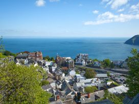 A coastal view of buildings and ocean at Rookery Cottage in Lynton