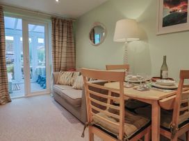 A dining room with a table and chairs at Cherry Pip in Charmouth