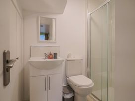 A bathroom with a sink and shower at Cherry Pip in Charmouth