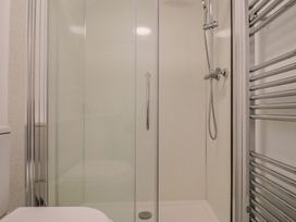 A bathroom with a shower and toilet at Cherry Pip in Charmouth