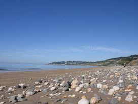 A beach with rocks and water at Cherry Pip in Charmouth