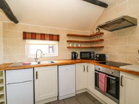 A kitchen with sink and appliances at 1 Small in Malton